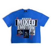 A blue short-sleeve graphic t-shirt featuring the text 'MIXED EMOTION' in distressed white letters inside a black block, with smaller black-and-white images and red splatter details on the front, shown against a plain white background.