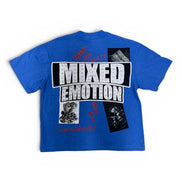 A blue short-sleeve t-shirt with a large graphic print on the back. The graphic features the text 'MIXED EMOTION' in distressed white letters inside a black rectangle, with red text reading 'WHO DARES WINS' above it and smaller black-and-white collage images below.