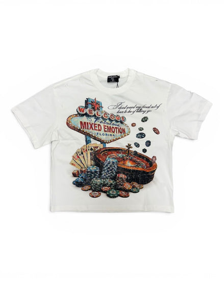 A white short-sleeve graphic t-shirt featuring a Las Vegas 'Welcome to Fabulous City of Mixed Emotion' sign surrounded by poker chips and a roulette wheel.