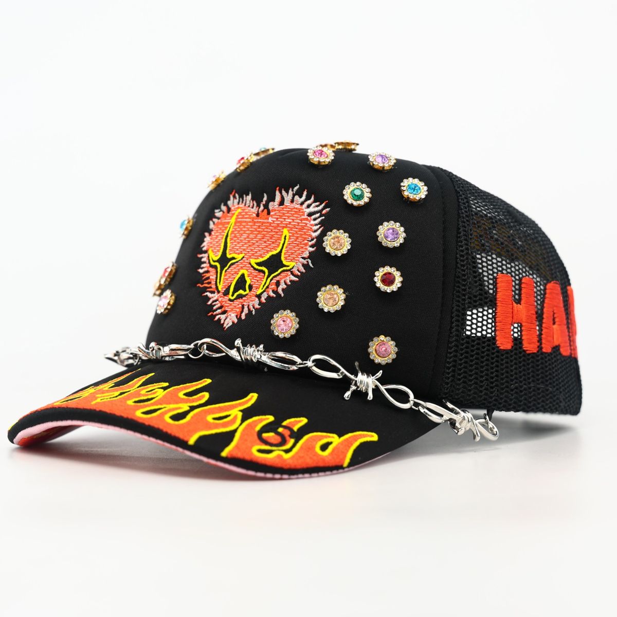 Black cap with colorful embellishments and 'HALF LASH' branding on a white background