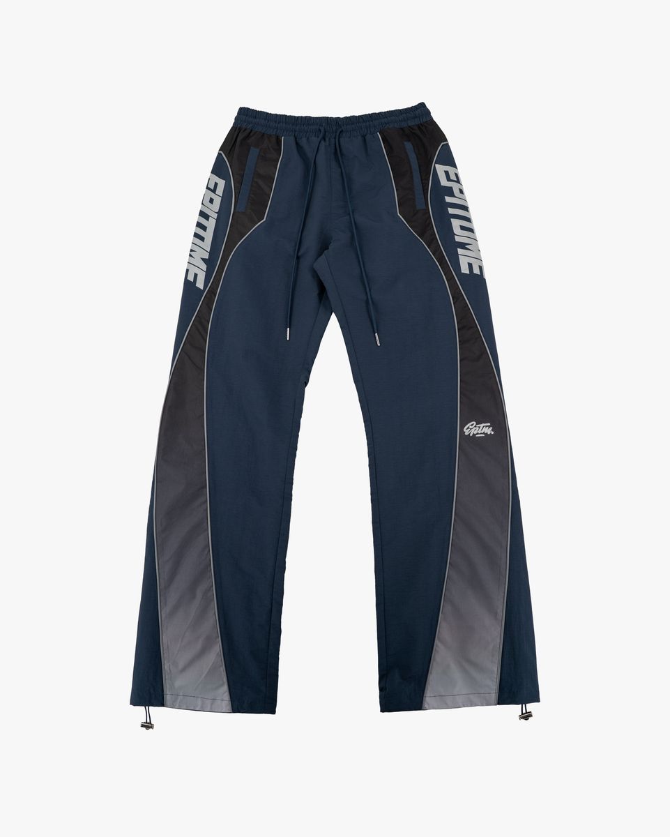 A pair of navy blue athletic pants with dark gray side panels and white 'EPITOME' branding printed vertically on the thighs, shown against a plain light gray background.
