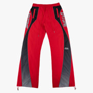 Red and black athletic pants with white 'EPITOME' text on the sides and a small white logo near the lower right leg, shown flat against a light gray background.