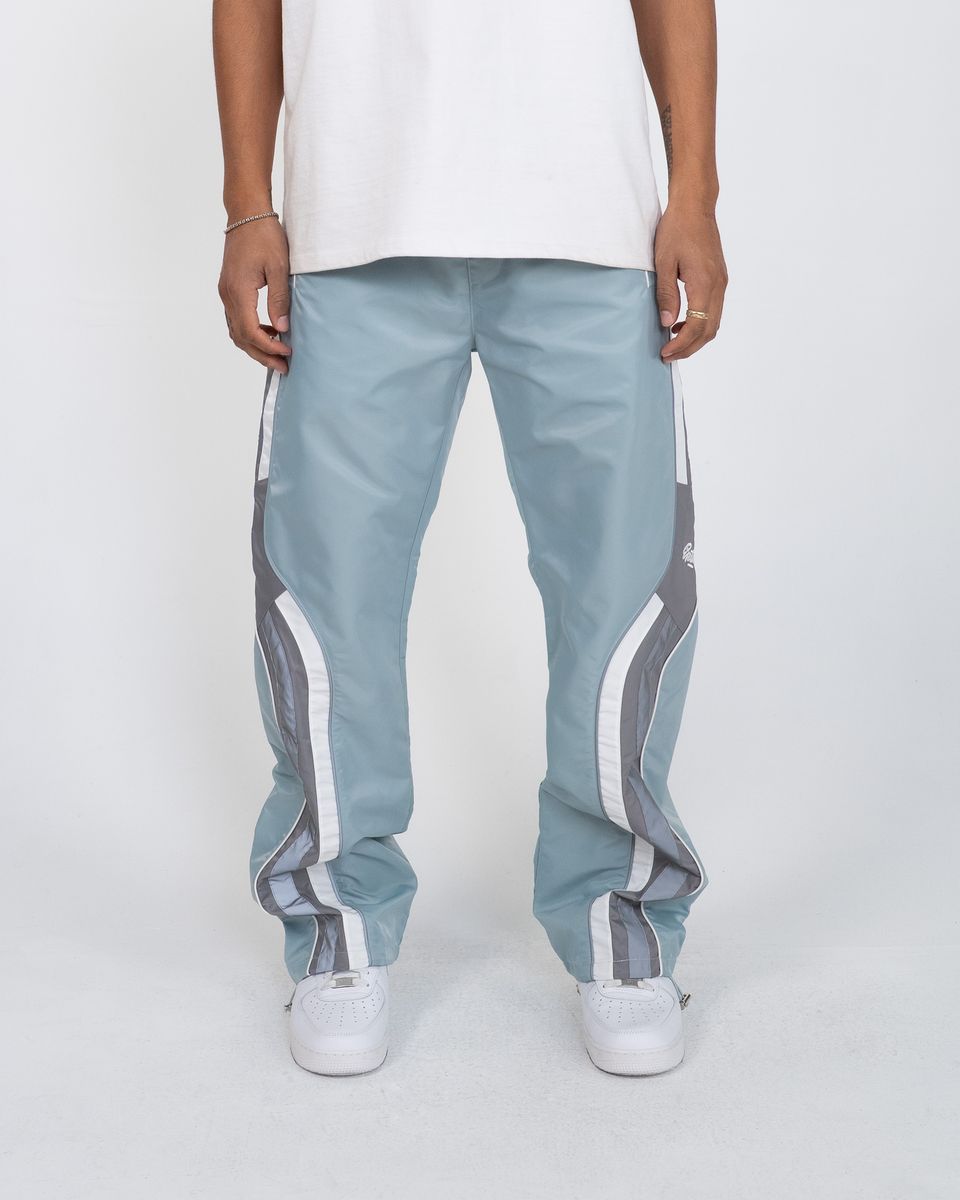 Light blue pants with white stripes worn by a person on a white background