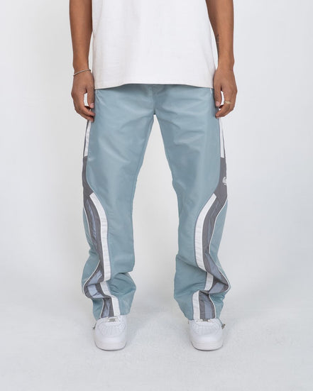 Light blue pants with white stripes worn by a person on a white background