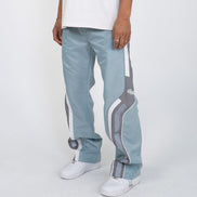 Light blue track pants with white and gray stripes worn by a person on a white background