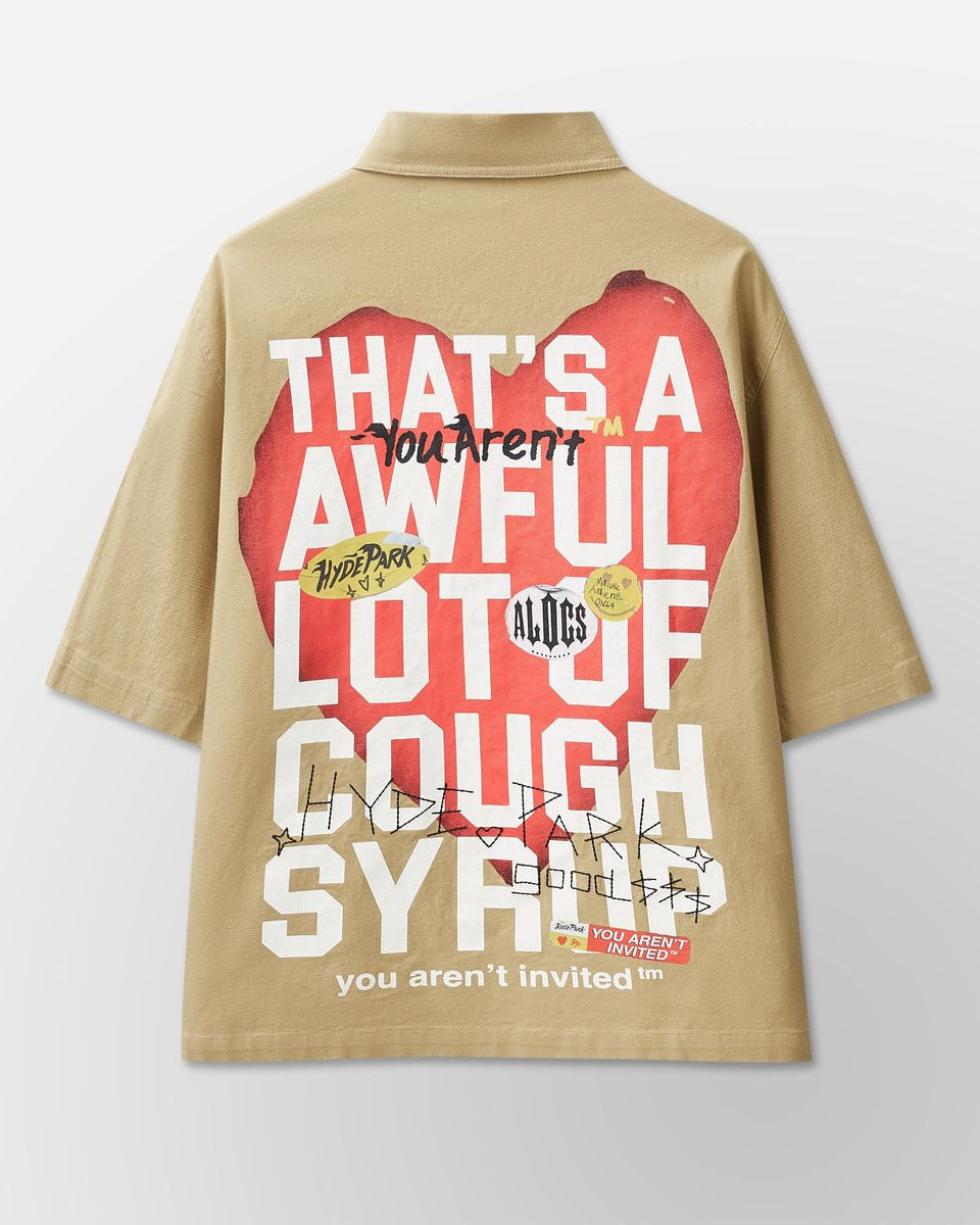Beige shirt with graphic design and text on a light gray background