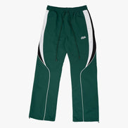 Green track pants with white side panels on a white background