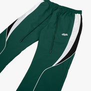 Green and white tracksuit pants with a brand logo on a white background
