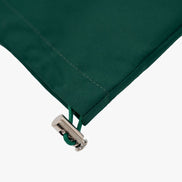 Close-up of a green fabric with a metal zipper on a white background