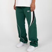 Green track pants with white and black accents worn by a person on a white background