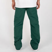 Green pants worn by a person on a white background