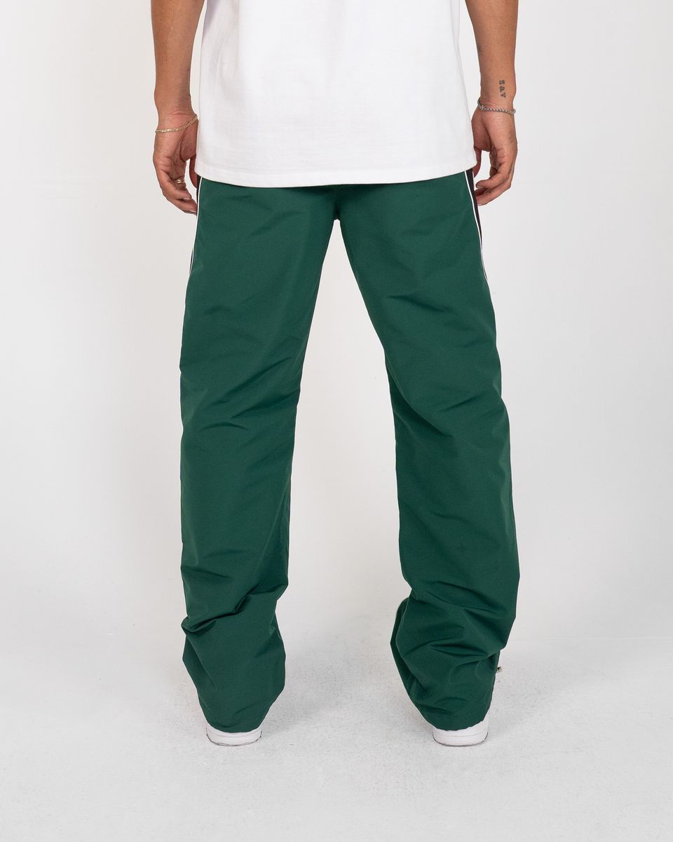 Green pants worn by a person on a white background