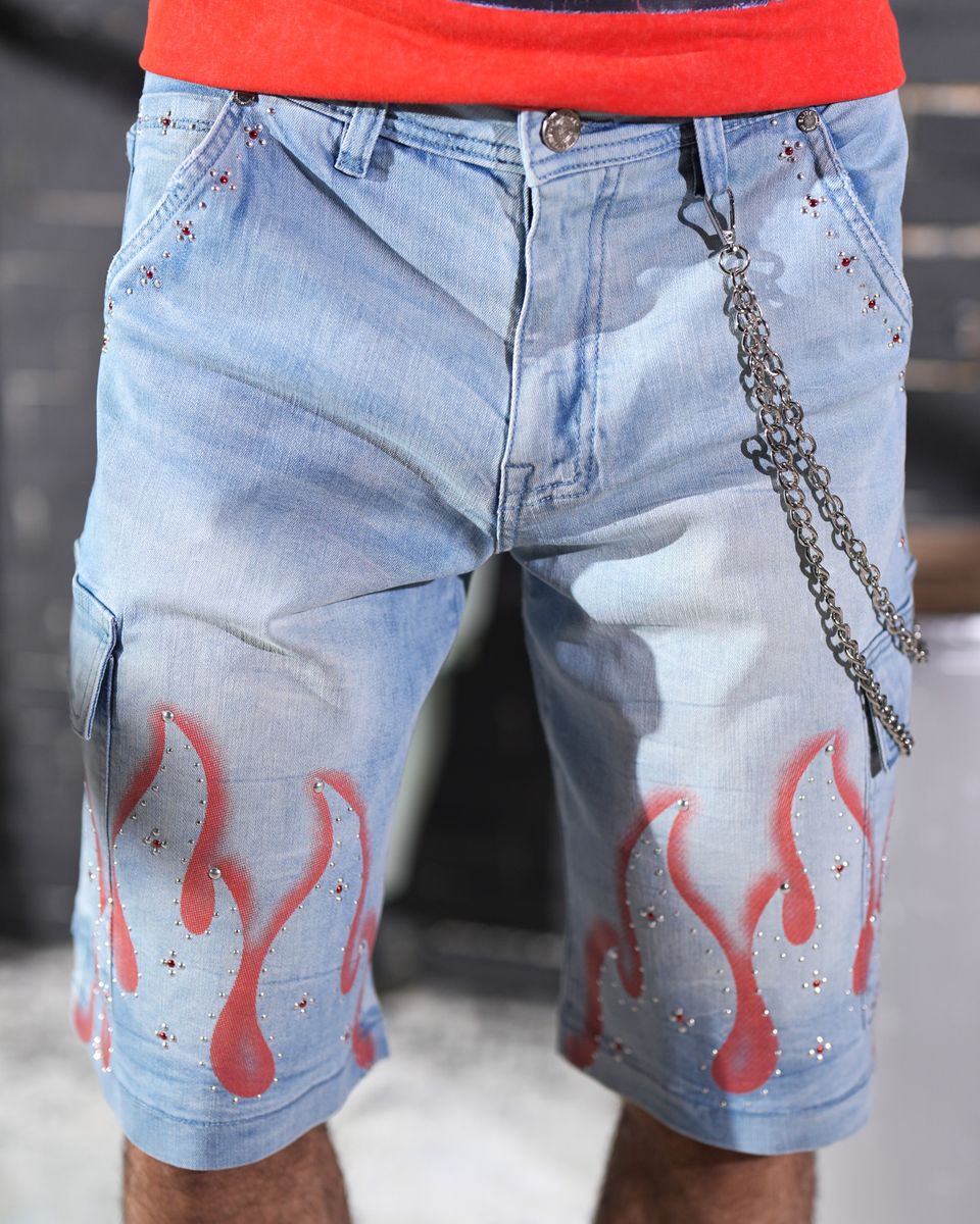 Blue denim shorts with red flame designs and a chain detail worn by a person.