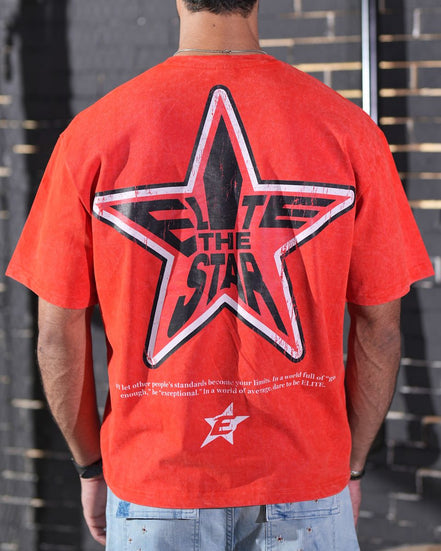 Person wearing a red t-shirt with a star design and text on the back.