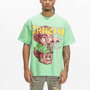 Person wearing a light green t-shirt with a graphic design on a white background