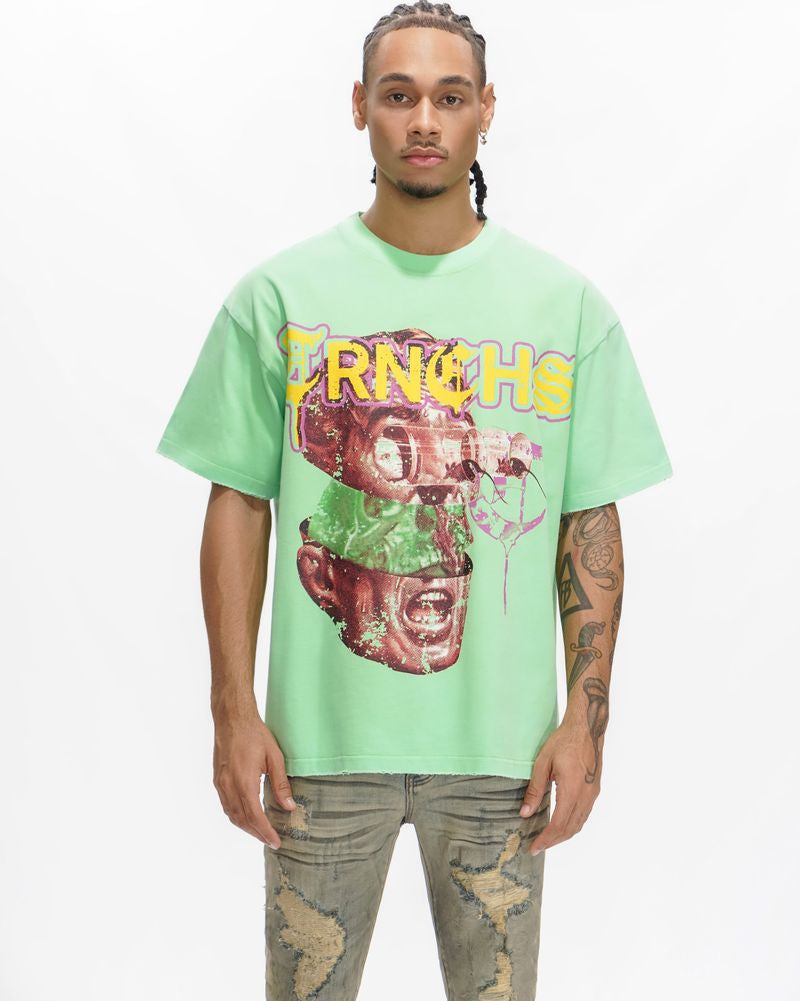 Person wearing a light green t-shirt with a graphic design on a white background