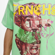Person wearing a green t-shirt with a graphic design and text.