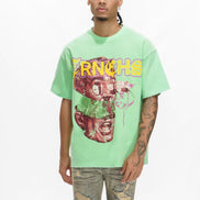Person wearing a light green t-shirt with graphic design and text on a white background