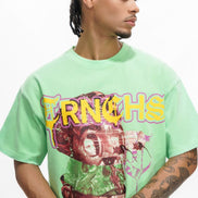 Person wearing a green t-shirt with a graphic design and text