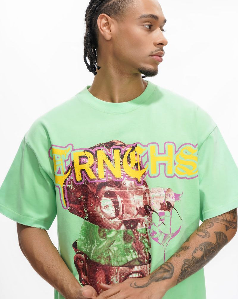 Person wearing a green t-shirt with a graphic design and text