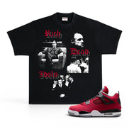 A black graphic t-shirt featuring a 'Rich White' theme with red Gothic lettering and black-and-white photos of Tony Montana, displayed next to a red and black Air Jordan 4 sneaker on a white background.