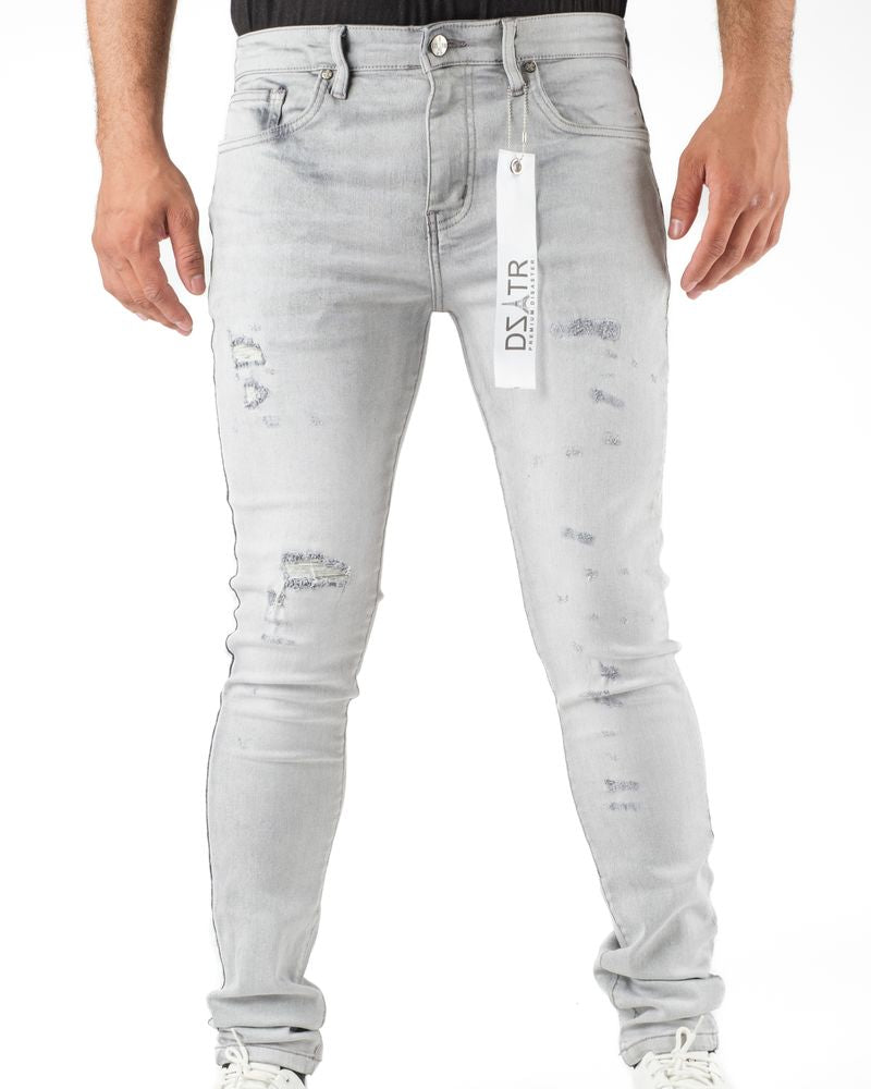 Light gray distressed jeans with a brand tag on a white background