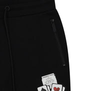 Black pants with card design patches on a white background
