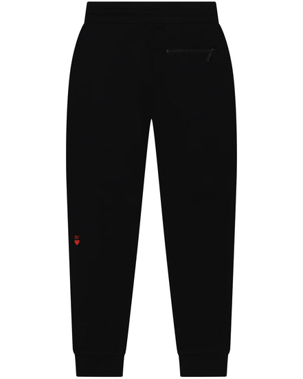 Black pants with a small red heart detail on a white background