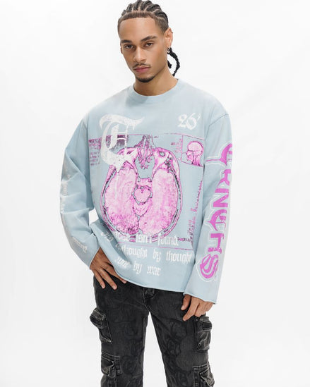 Person wearing a light blue sweatshirt with pink graphics on a white background