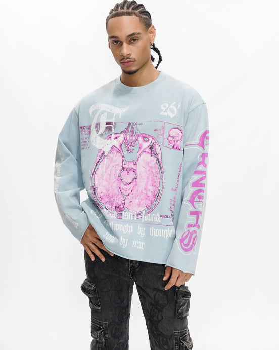 Person wearing a light blue sweatshirt with pink graphics on a white background