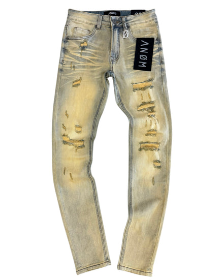 Distressed light-colored jeans with a brand label on a white background