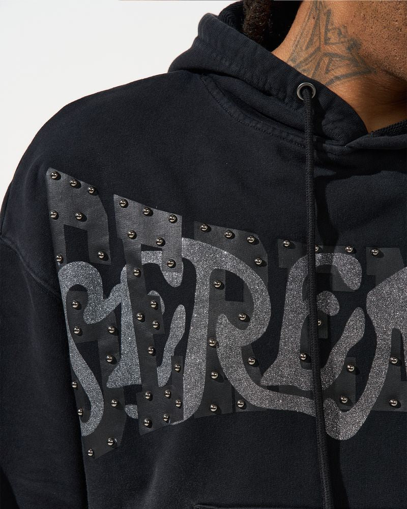 Black hoodie with 'Metallica' logo featuring studs on a white background