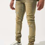 Beige distressed jeans worn by a person on a white background