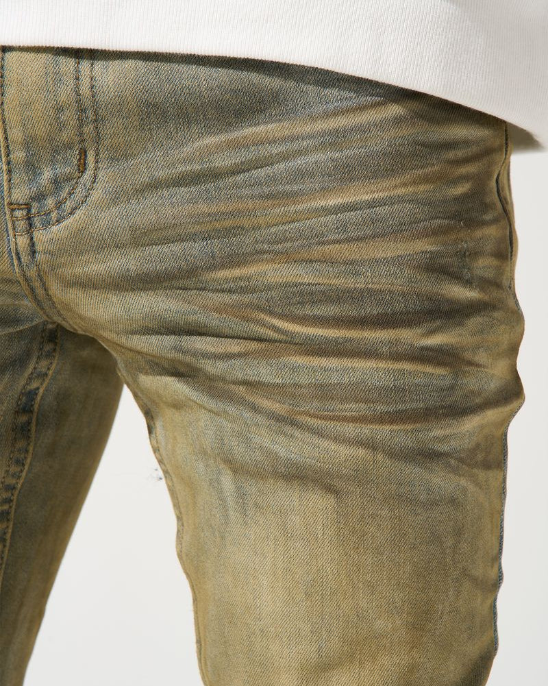 Close-up of beige jeans on a white background