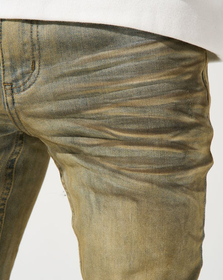 Close-up of beige jeans on a white background