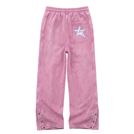 Pink corduroy pants with an elastic waistband, a back pocket featuring a white embroidered star with a blue outline, and snap-button details on the lower legs.
