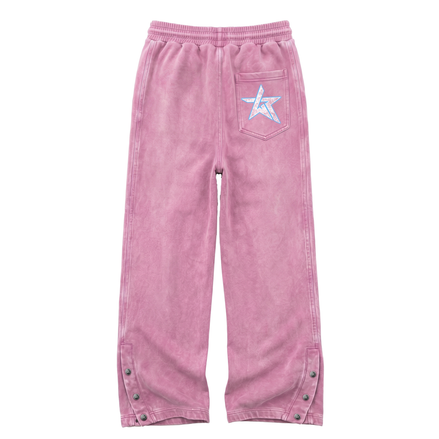 Pink corduroy pants with an elastic waistband, a back pocket featuring a white embroidered star with a blue outline, and snap-button details on the lower legs.