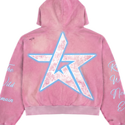 A pink acid-wash hoodie shown from the back, featuring a large distressed white star graphic outlined in light blue on the back, with white script text printed on both sleeves.