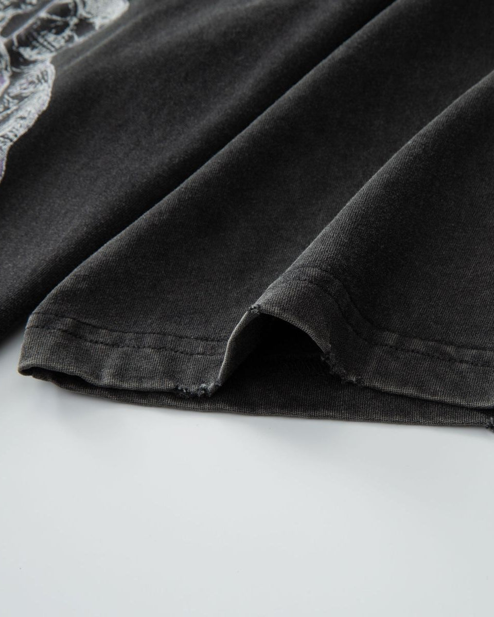 Close-up of a black garment with lace trim on a white background