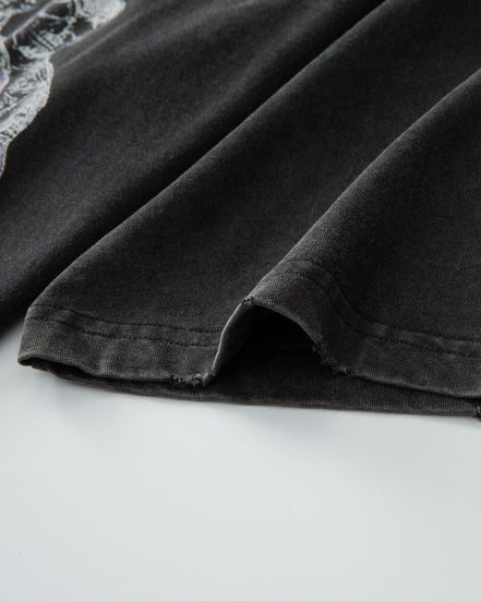 Close-up of a black garment with lace trim on a white background