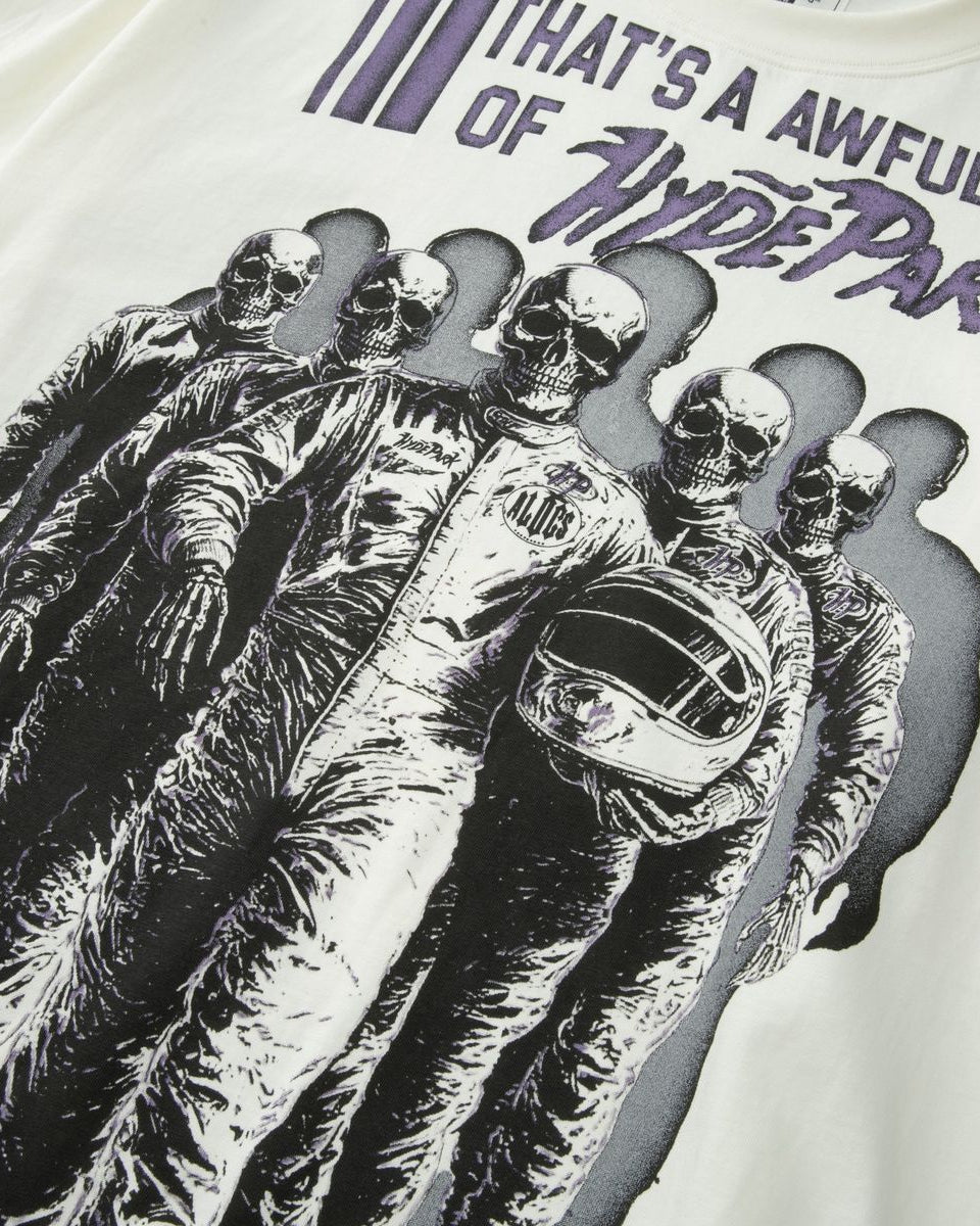 White t-shirt with black and purple graphic design of a person in racing gear and helmet, with text above.