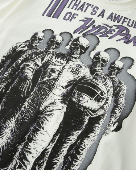 White t-shirt with black and purple graphic design of a person in racing gear and helmet, with text above.