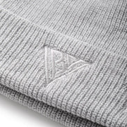 Close-up of a gray knit beanie with a brand logo on a white background