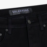 Black jeans with 'VALABASAS' label on a white background