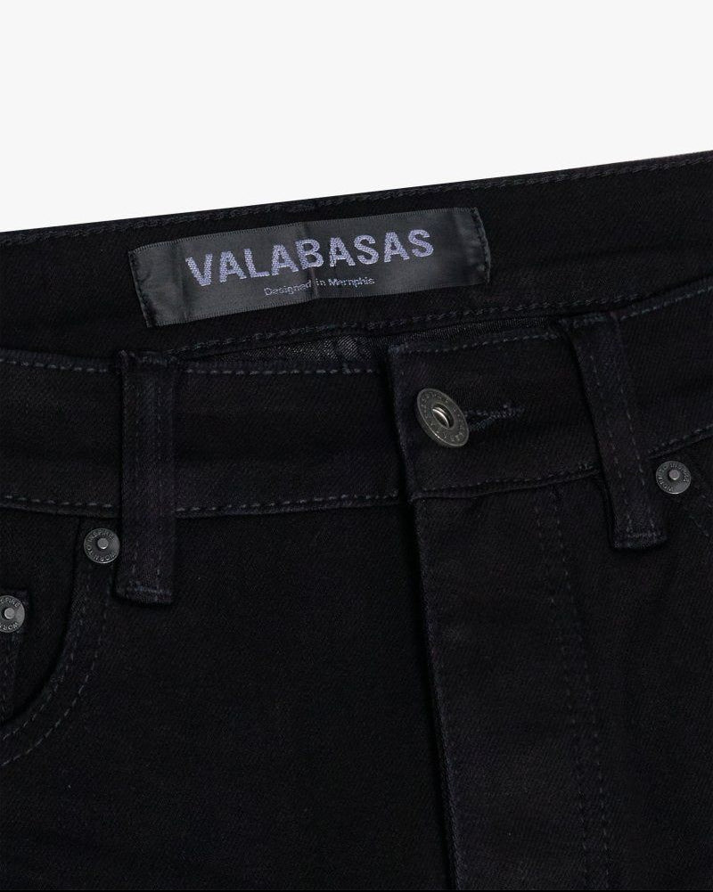 Black jeans with 'VALABASAS' label on a white background