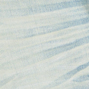 Close-up of light blue denim fabric with a subtle pattern