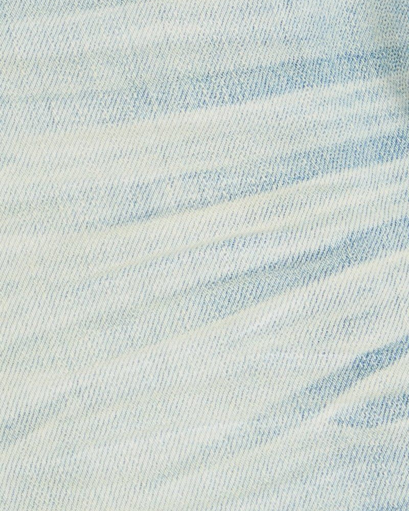 Close-up of light blue denim fabric with a subtle pattern