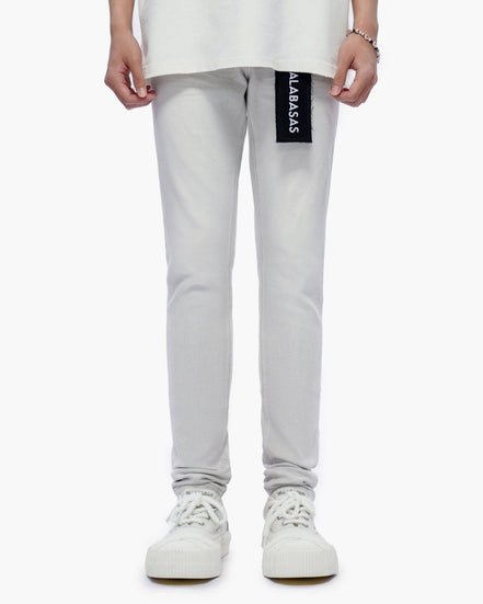 Light gray jeans with a brand label on a white background