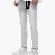 Person wearing light gray jeans with a brand logo on a white background