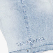Light blue denim shorts with 'VALABASAS' branding on a white background